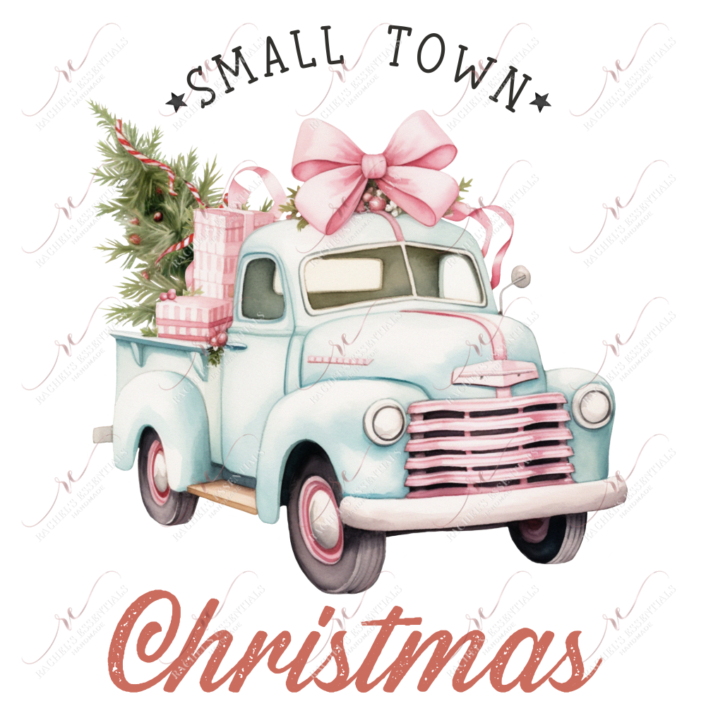 light blue & pink vintage truck with a large pink bow on top. The back of the truck is filled with pink wrapped presents and a green christmas tree